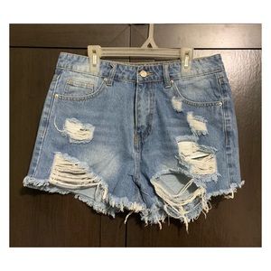 Brand new. Never worn. Blue distressed jean shorts from Shein.